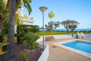 a house with a swimming pool and a street light at Costa Bella in Altea