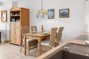 a dining room with a wooden table and chairs at Deichblick in Böhl +12 photos