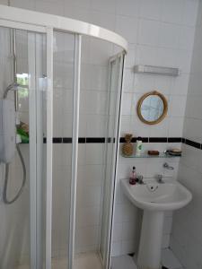 a bathroom with a shower and a sink at Townhouse in Castleisland +19 photos