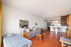 a living room with two beds and a kitchen at Cabanas Mar 94 in Cabanas de Tavira