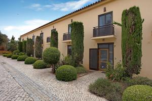a building with a row of trees in front of it at Arrancada 7 in São Lourenço