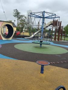a playground with a slide in a park at Townhouse in Castleisland