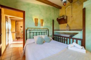 a bedroom with a bed and a kitchen with a sink at El Mirador in Laroya +18 photos