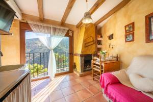 a kitchen and living room with a large window at El Mirador in Laroya