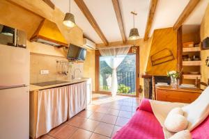 a kitchen with a refrigerator and a counter top at El Mirador in Laroya