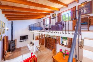 a large living room with a spiral staircase and a living room at Can Me Sents in Pollença