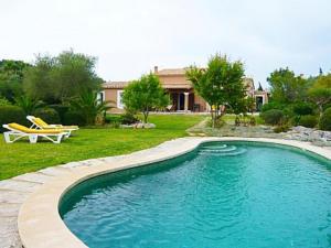 a swimming pool in a yard next to a house at Can Me Sents in Pollença
