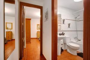 a bathroom with a toilet and a sink at Mi refugio en La Jaca in Arico +21 photos