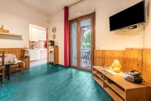 a living room with a television on the wall at App Oleandro Casa Demonti in Tignale