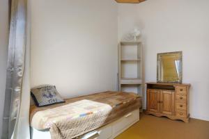 a small bedroom with a bed and a mirror at Ty Dacoli - piscine et plage in Le Pouliguen +16 photos