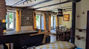 a living room with a couch and a table at Le Gite Des Peyreyres in Lespéron