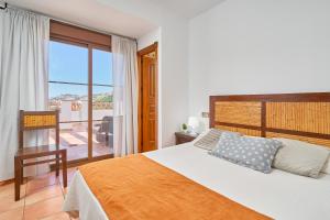 a bedroom with a large bed and a balcony at Costa Luxe Almuñecar in Almuñécar +175 photos