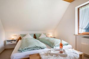 a bedroom with two beds with green pillows at Jorchenhof in Hofstetten
