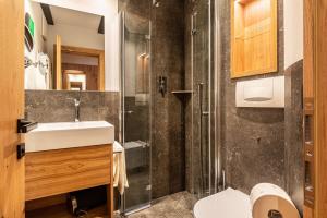 a bathroom with a sink and a shower at Residence Skutial App Santner in Castelrotto +21 photos