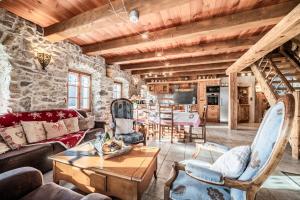 a living room with a couch and chairs and a table at la ferme de la Vora in Châtel