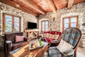 a living room with a stone wall at la ferme de la Vora in Châtel