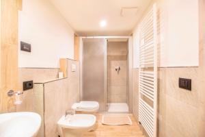 a bathroom with a shower and a toilet and a sink at Chalet Osmar Appartamento 2 in Campitello di Fassa +28 photos