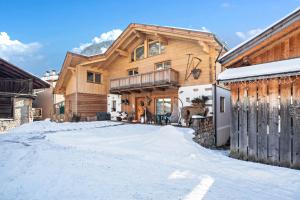 a log home in the winter with a lot of snow at Chalet Osmar Appartamento 2 in Campitello di Fassa