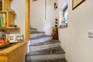 a group of stairs in a room with a counter at Stampferhof in Völs am Schlern +65 photos