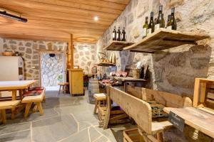 a tasting room with wine bottles on the wall at Stampferhof in Völs am Schlern