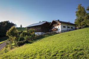 a house sitting on top of a green field at Stampferhof in Völs am Schlern