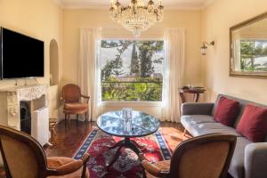 a living room with a couch and a table at Villa Echium T2 in Caniço
