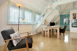 a living room with a table and a chair at Ferienappartement Pauli in Hagnau