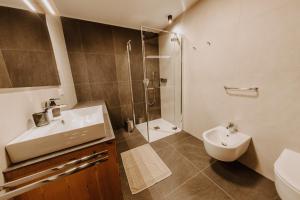 a bathroom with a sink and a shower and a toilet at Kieserhof Apartment Berg in Terento +22 photos