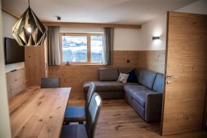 a living room with a couch and a table at Kieserhof Apartment Berg in Terento