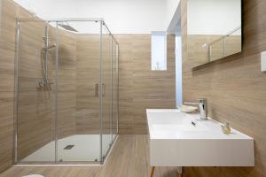 a bathroom with a shower and a white sink at Micenei Homes in Otranto +39 photos