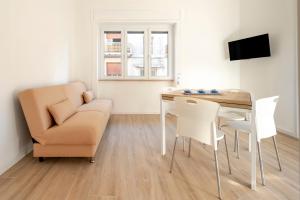 a living room with a table and a couch and a chair at Micenei Homes in Otranto