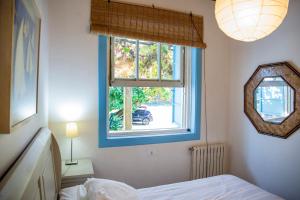 a bedroom with a bed and a window at Casa Con Encanto in Bueu +35 photos