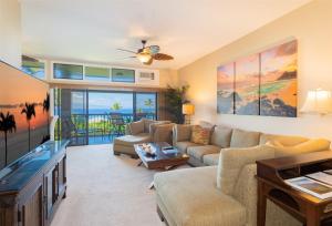 a living room with a couch and a tv at 2914 Ridge in Kahana