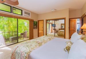 a bedroom with a bed and a large window at 2914 Ridge in Kahana +32 photos
