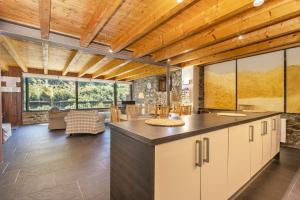 a large kitchen with a large island in a house at Casa Guillem Completa in Tavascan