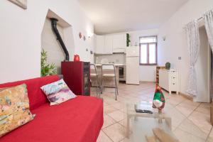 a living room with a red couch and a table at La Nicchia in Tirli