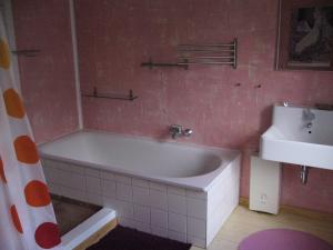 a bathroom with a bath tub and a sink at Ferienhaus in Waren an der Müritz in Waren +19 photos