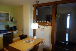 a kitchen with a wooden table with a lamp on it at Ferienhaus in Waren an der Müritz in Waren