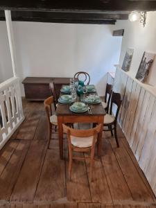 a dining room with a wooden table and chairs at Casa Grande in Falmenta +26 photos