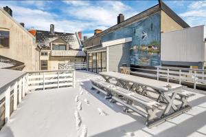a patio with a picnic table on top of a building at Sunny Central in Kristiansand