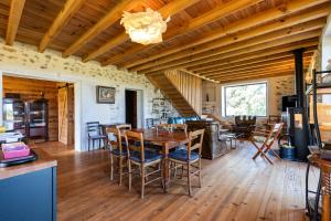 a dining room and living room with a table and chairs at Le Basque - Bazas in Bazas