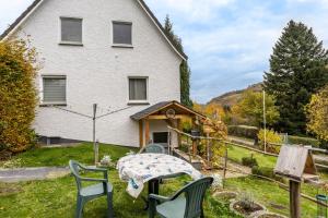a table and chairs in front of a house at Yalet Ferienhaus in Brilon