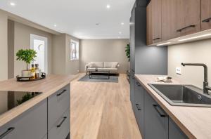 a kitchen with a sink and a counter top at Sunny Central in Kristiansand +28 photos