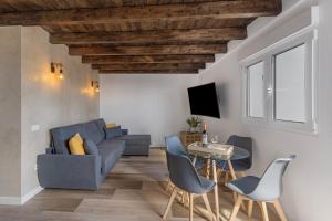 a living room with a couch and a table and chairs at Casa Miranda 2 in Araya