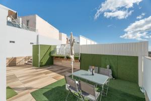 a patio with a table and chairs on top of a building at Casa Miranda 2 in Araya