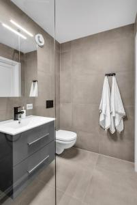 a bathroom with a sink and a toilet at Sunny Central in Kristiansand