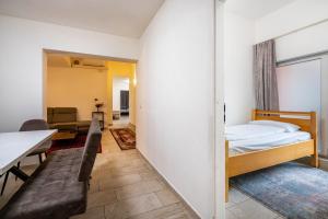 a bedroom with a bed and a dining room at Aldars Urban Loft Suite No.8 in Munich