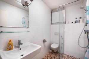 a bathroom with a sink and a shower at Aldars Urban Loft Suite No.8 in Munich +20 photos