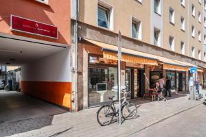 a bike parked on a sidewalk in front of a store at Aldars Urban Loft Suite No.8 in Munich