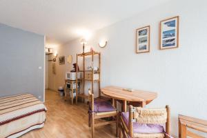a room with a table and a bed and a bedroom at Studio Barèges ski, rando, cure in Barèges